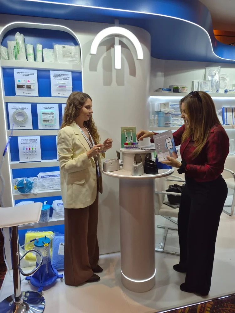 Terragene representative demonstrating sterilization products at the Droguería Comarsa stand in Salta, Argentina.